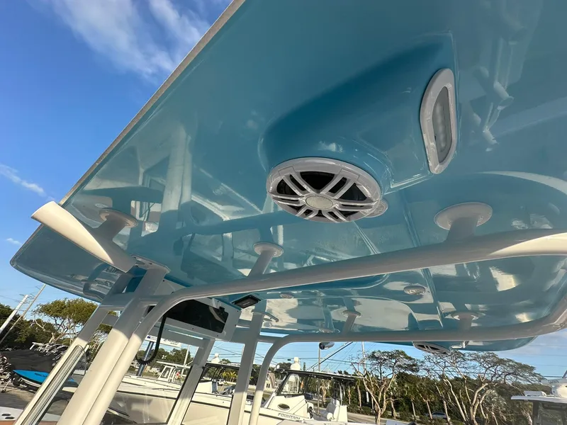 Slide: The Image of 2024 NauticStar 292 Legacy boat with blue hardtop and speaker system. - 45