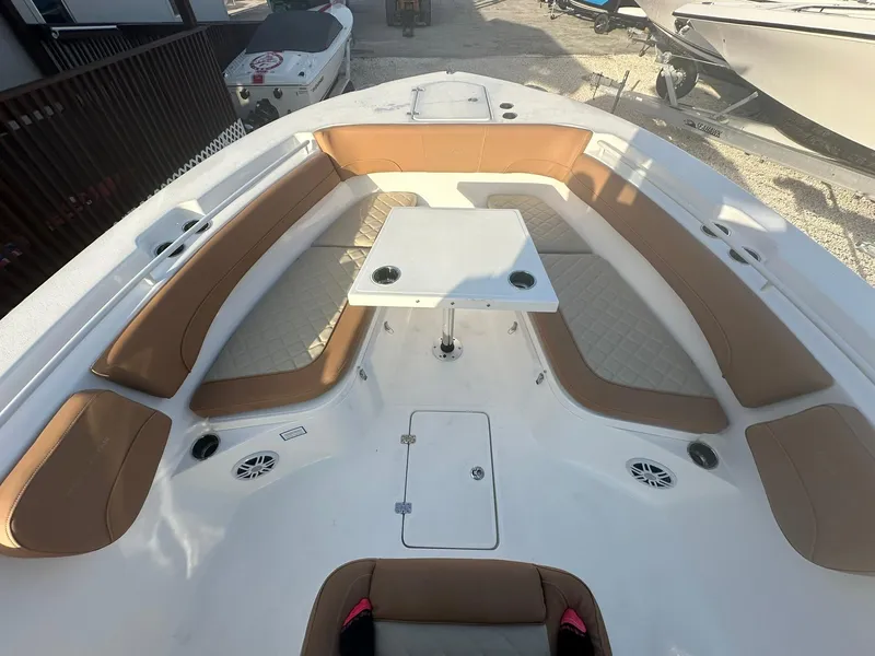Slide: The Image of 2024 NauticStar 292 Legacy boat with spacious seating and table. - 7