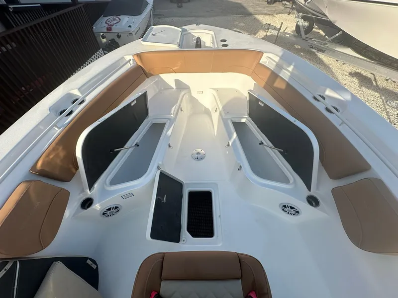 Slide: The Image of 2024 NauticStar 292 Legacy boat interior with tan seating and storage compartments. - 9