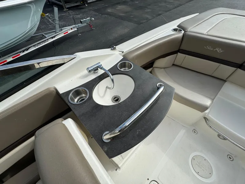 Slide: The Image of 2013 Sea Ray 250 SLX boat interior with sink and seating area. - 10