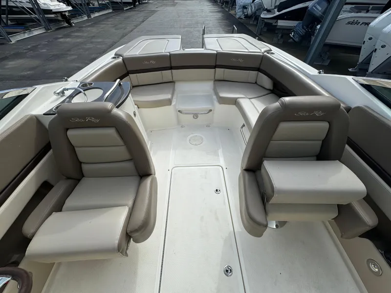 Slide: The Image of 2013 Sea Ray 250 SLX boat interior with beige seating and spacious layout. - 11