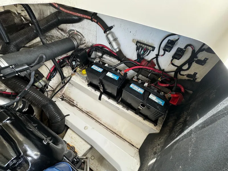 Slide: The Image of Engine compartment of a 2013 Sea Ray 250 SLX boat with batteries and wiring. - 16