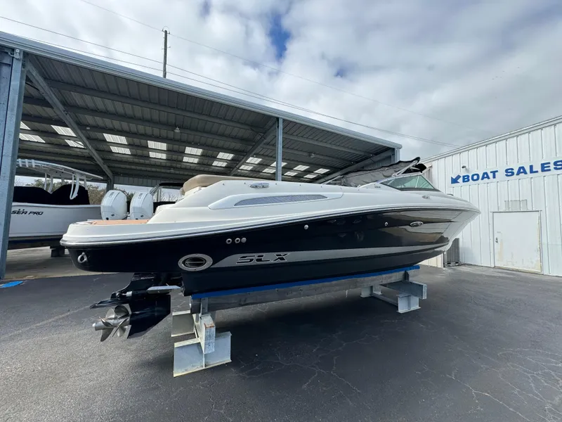 Slide: The Image of 2013 Sea Ray 250 SLX boat on display at a boat sales lot. - 6