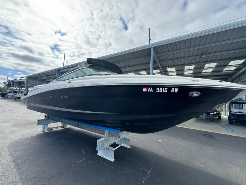 Slide: The Image of 2013 Sea Ray 250 SLX boat on a stand under a cloudy sky. - 7