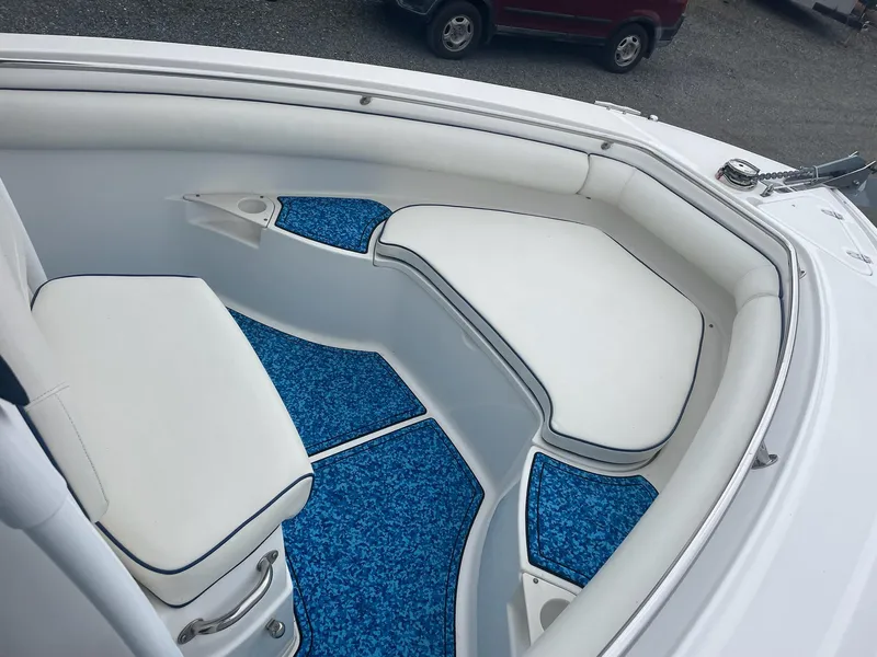 Slide: The Image of Interior of a 2005 Boston Whaler Outrage 240 with blue carpeting. - 10