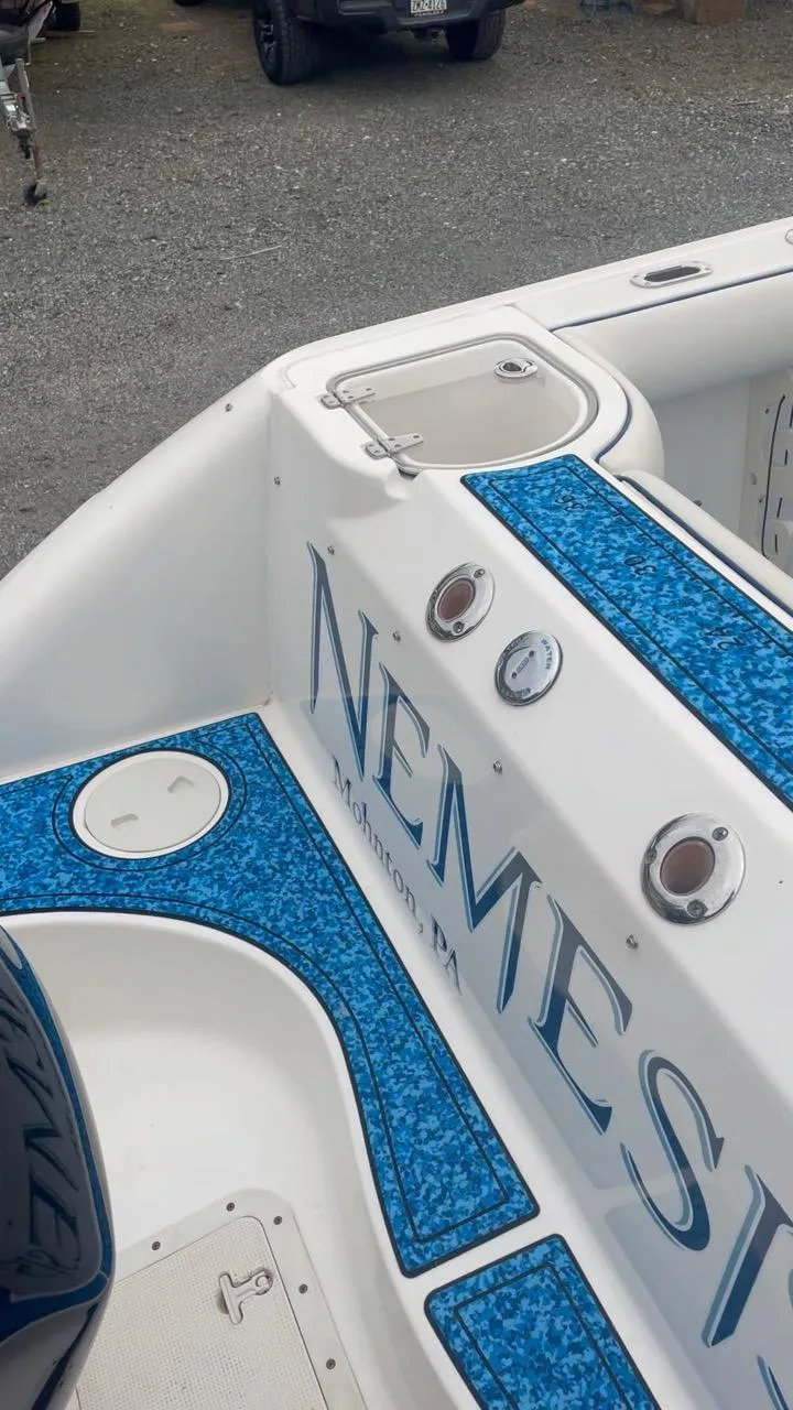 Slide: The Image of Boston Whaler Outrage 240 boat, 2005 model, featuring blue upholstery. - 11