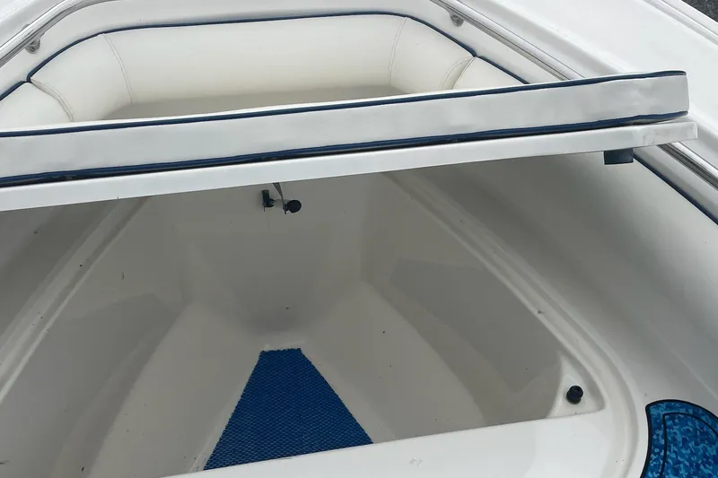 Slide: The Image of Boston Whaler Outrage 240 2005, open storage compartment with blue mat. - 14