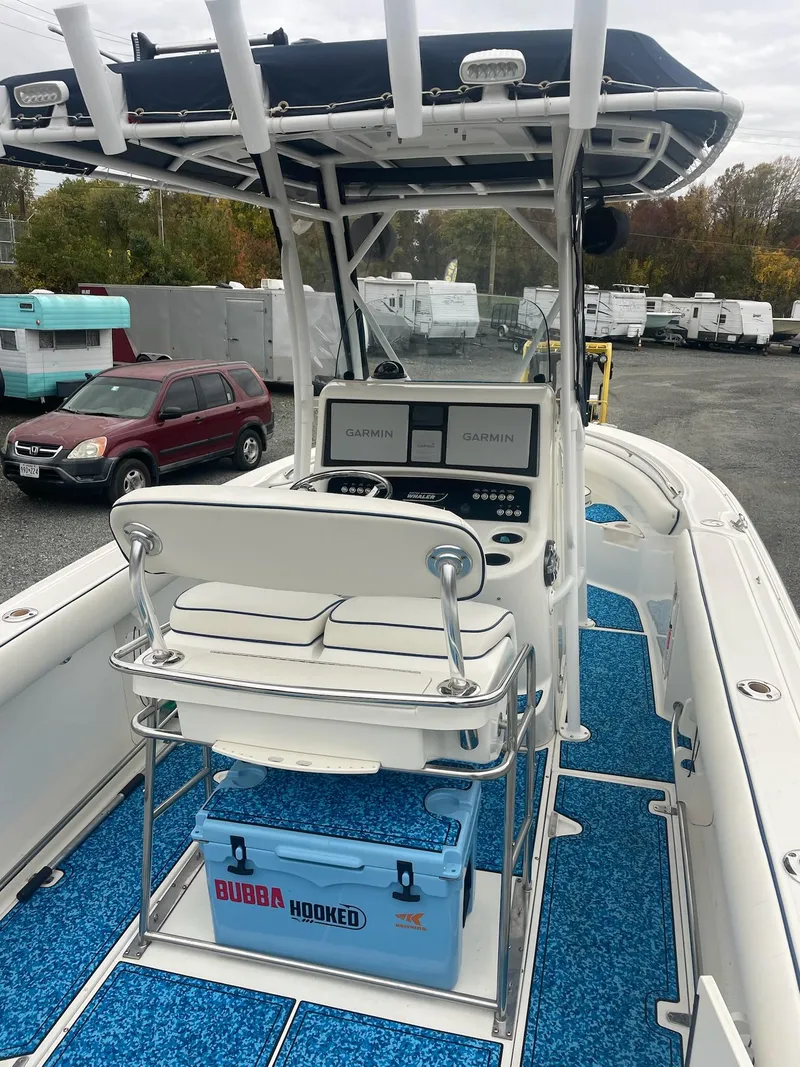 Slide: The Image of 2005 Boston Whaler Outrage 240 boat with blue cooler. - 15
