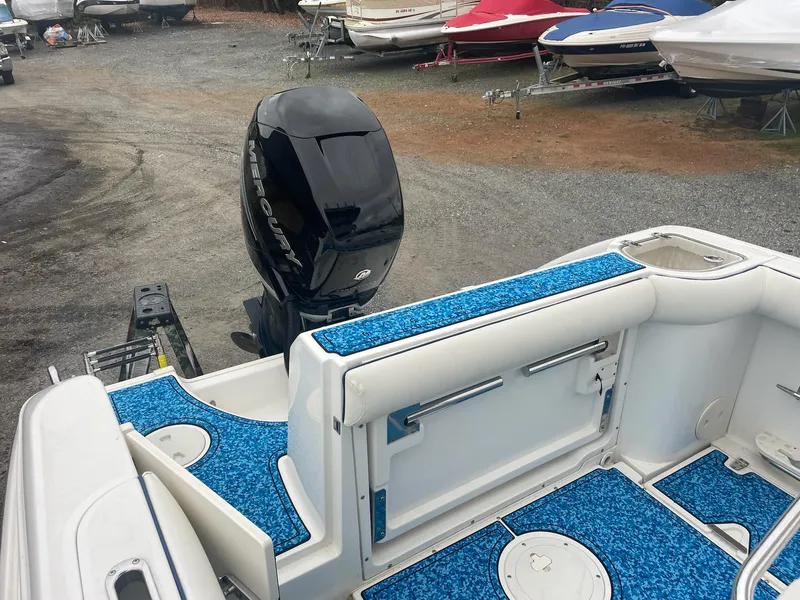 Slide: The Image of 2005 Boston Whaler Outrage 240 with blue deck and outboard motor. - 16