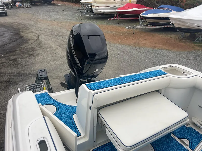 Slide: The Image of 2005 Boston Whaler Outrage 240 boat with blue carpet and outboard motor. - 17
