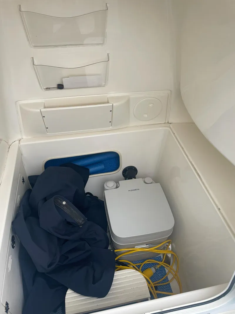 Slide: The Image of Interior of a 2005 Boston Whaler Outrage 240 with storage and equipment. - 19