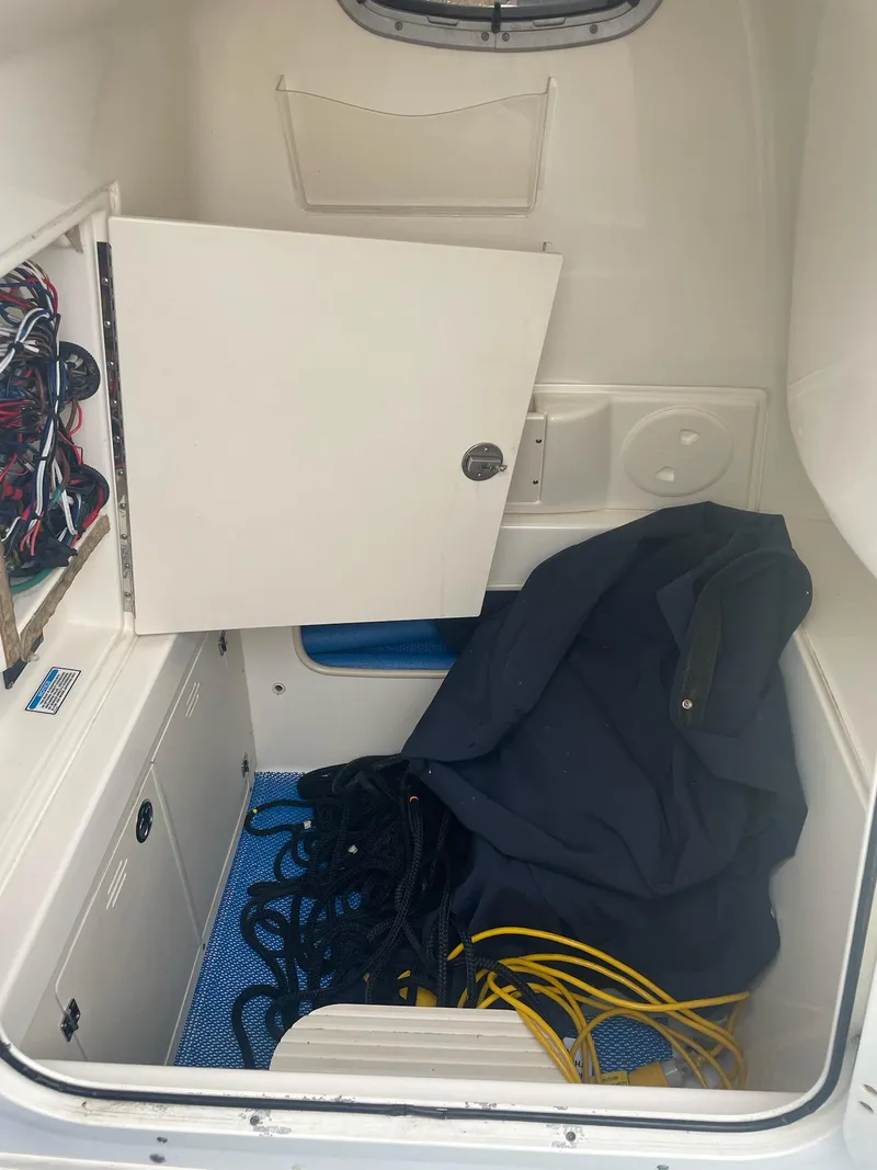 Slide: The Image of Interior of a 2005 Boston Whaler Outrage 240 with storage and ropes. - 20