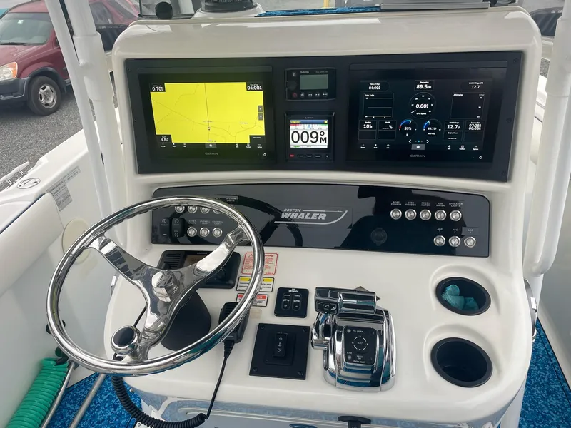 Slide: The Image of 2005 Boston Whaler Outrage 240 helm with modern navigation instruments. - 7