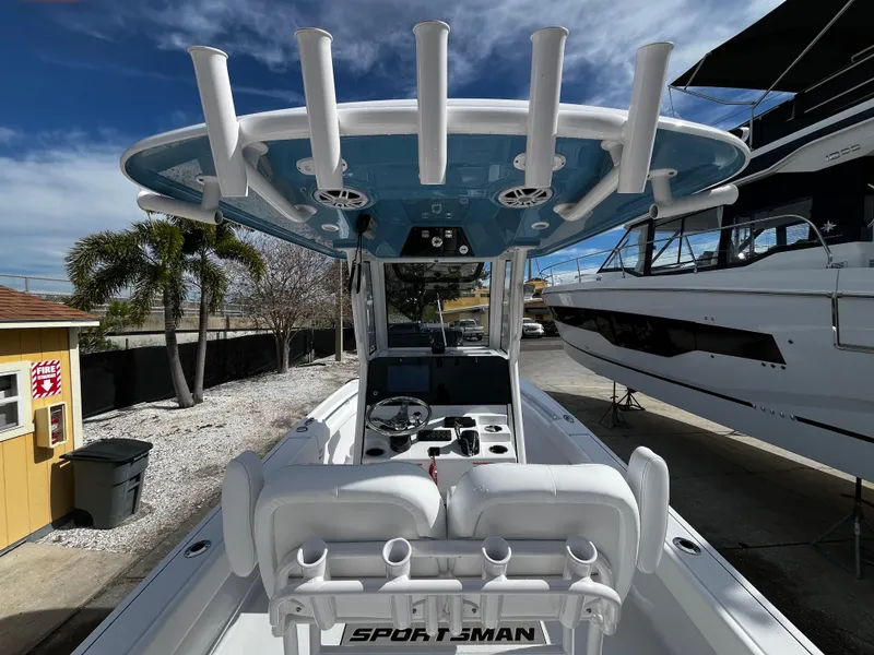 Slide: The Image of 2024 Sportsman Masters 247OE Bay Boat, interior view with rod holders and helm station. - 12