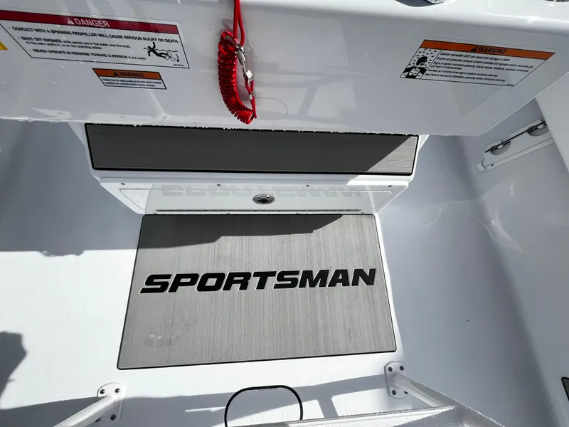 Slide: The Image of 2024 Sportsman Masters 247OE Bay Boat interior with logo and safety warnings. - 16