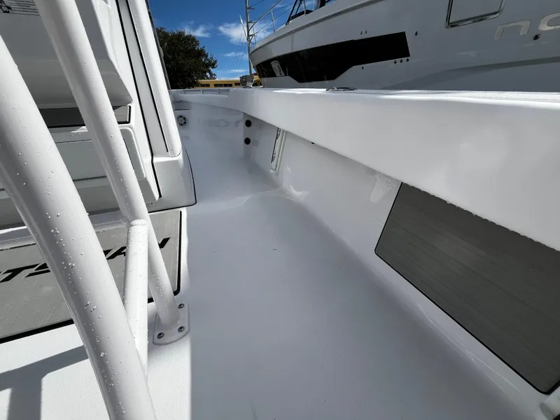 Slide: The Image of 2024 Sportsman Masters 247OE Bay Boat deck view, showcasing sleek white interior and modern design. - 18