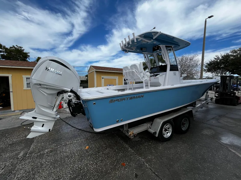 Slide: The Image of 2024 Sportsman Masters 247OE Bay Boat on trailer with Yamaha outboard motor. - 2