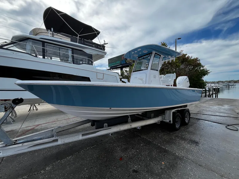 Slide: The Image of 2024 Sportsman Masters 247OE Bay Boat on trailer at marina. - 4
