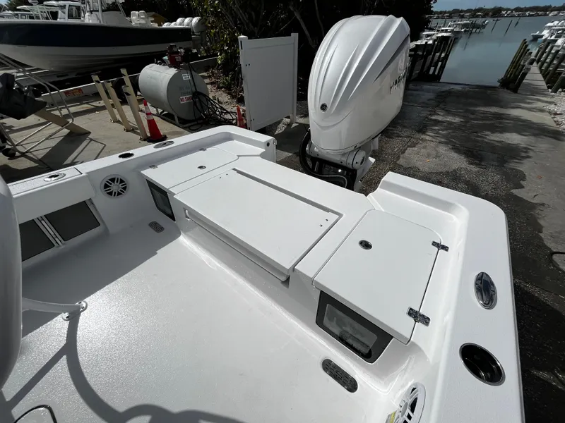 Slide: The Image of 2024 Sportsman Masters 247OE Bay Boat at dock with outboard motor. - 7