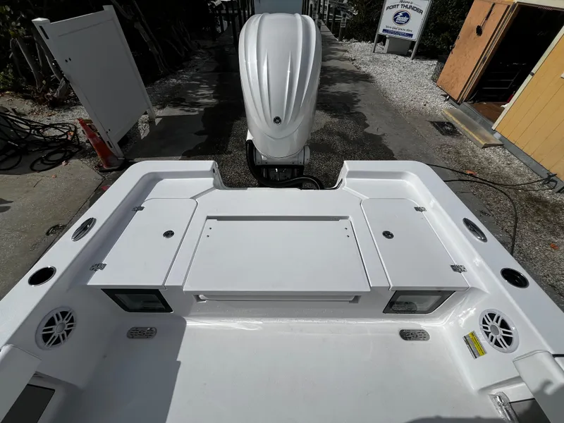 Slide: The Image of 2024 Sportsman Masters 247OE Bay Boat stern view with outboard motor. - 9