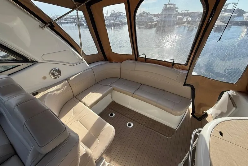 Slide: The Image of 2009 Formula 31 Performance Cruiser interior with beige seating and marina view. - 13