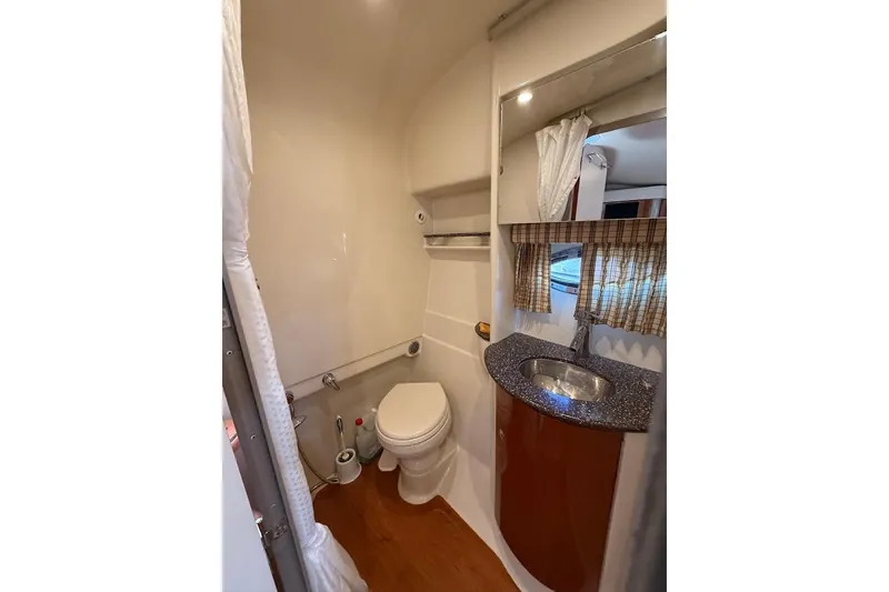 Slide: The Image of 2009 Formula 31 Performance Cruiser bathroom with toilet, sink, and mirror. - 17