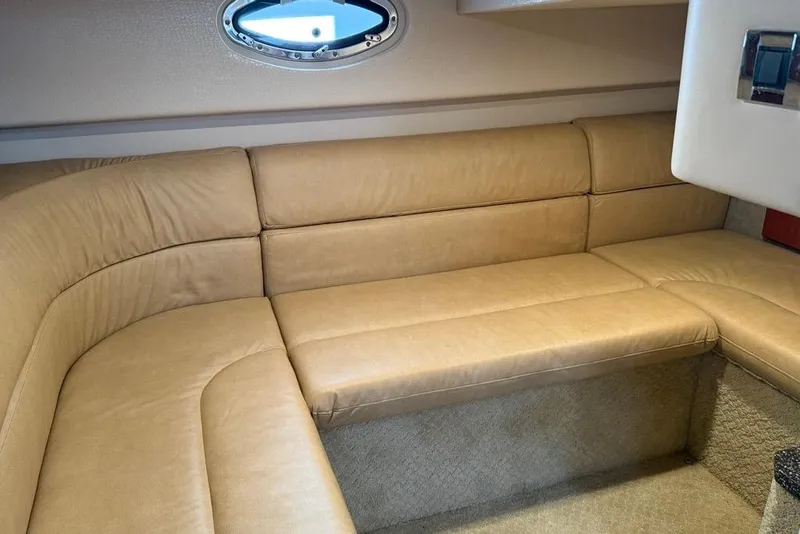Slide: The Image of 2009 Formula 31 Performance Cruiser interior with beige leather seating and porthole window. - 18