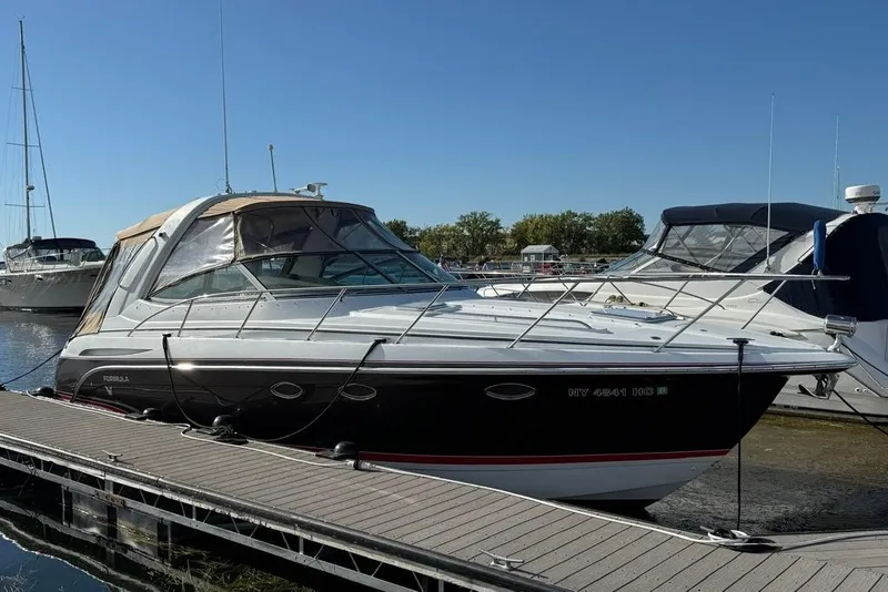 Slide: The Image of 2009 Formula 31 Performance Cruiser docked at marina under clear blue sky. - 5