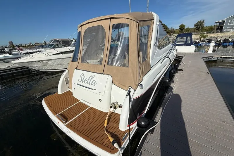Slide: The Image of 2009 Formula 31 Performance Cruiser docked, featuring tan canopy and wooden deck. - 6