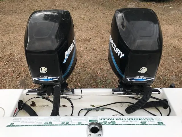 Slide: The Image of Twin Mercury outboard engines on a 2005 Mako 284 CC boat. - 5