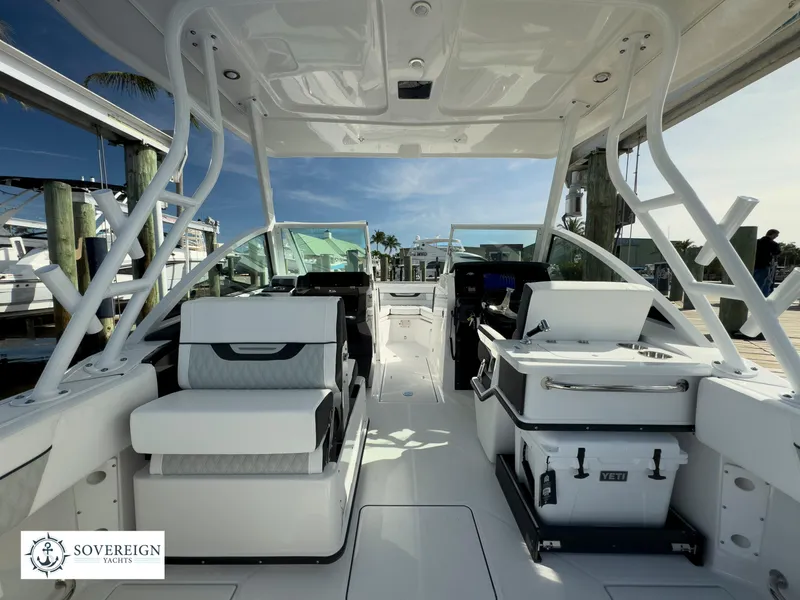 Slide: The Image of 2024 Blackfin 252 DC boat interior with seating and console, docked at marina. - 16
