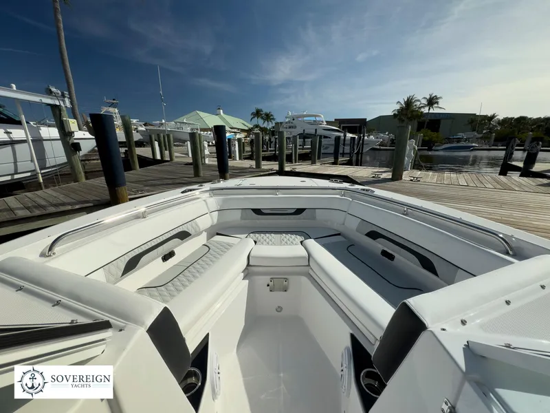 Slide: The Image of 2024 Blackfin 252 DC boat docked at a marina with seating area. - 18