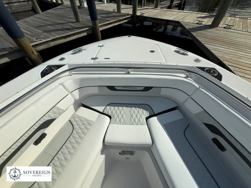 Slide: The Image of 2024 Blackfin 252 DC boat bow seating area at dock. - 19