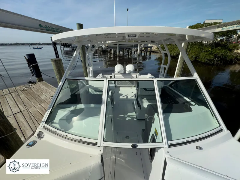 Slide: The Image of 2024 Blackfin 252 DC boat docked at marina, front view. - 23