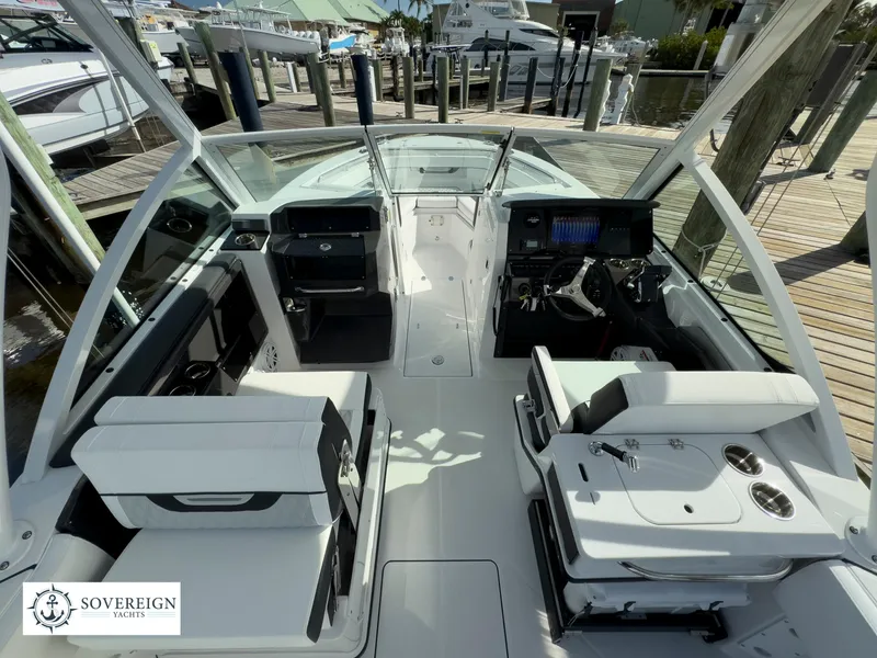 Slide: The Image of 2024 Blackfin 252 DC boat interior at dock, featuring modern seating and control panels. - 24