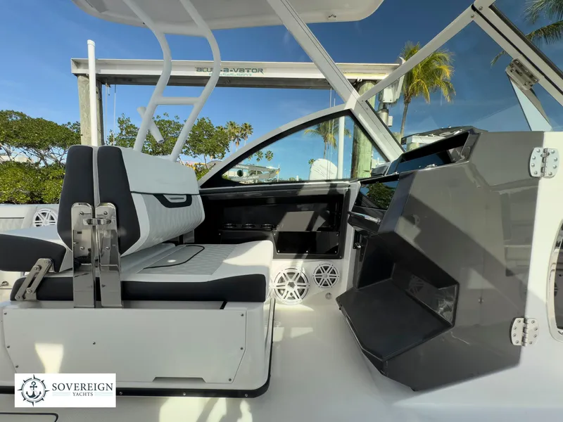 Slide: The Image of 2024 Blackfin 252 DC boat interior with seating and dashboard, Sovereign Yacht logo. - 27