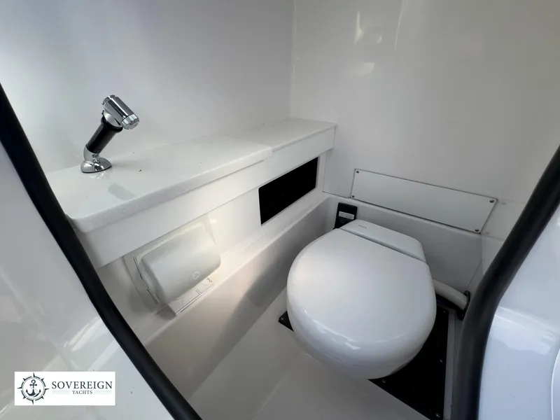 Slide: The Image of 2024 Blackfin 252 DC boat interior bathroom with toilet and sink. - 29
