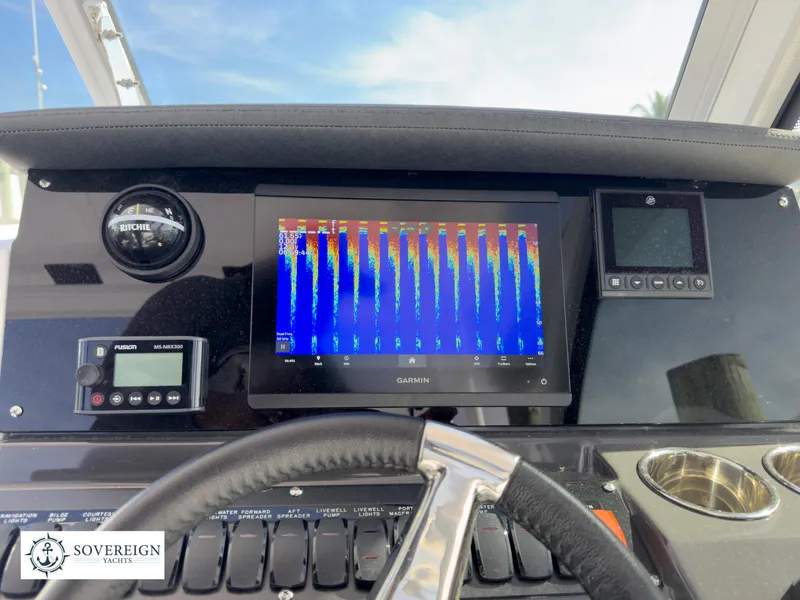 Slide: The Image of 2024 Blackfin 252 DC dashboard with Garmin display and controls. - 38