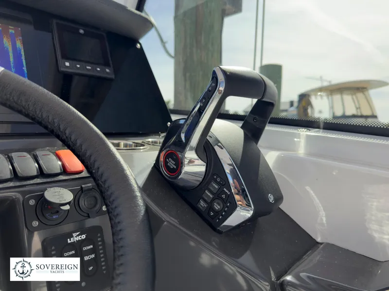 Slide: The Image of 2024 Blackfin 252 DC boat control panel with throttle and steering wheel. - 40