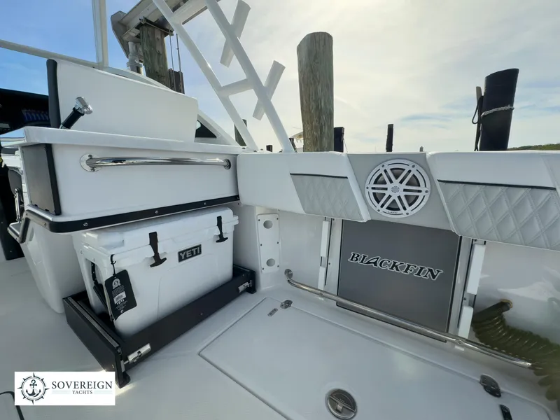 Slide: The Image of 2024 Blackfin 252 DC boat interior with Yeti cooler and Sovereign Yachts logo. - 46