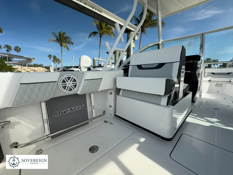 Slide: The Image of 2024 Blackfin 252 DC boat interior with seating and Sovereign Yachts logo. - 47