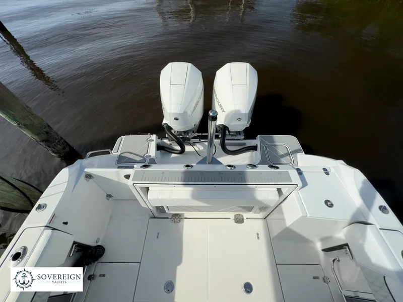 Slide: The Image of 2024 Blackfin 252 DC boat with twin outboard engines, viewed from the stern. - 48
