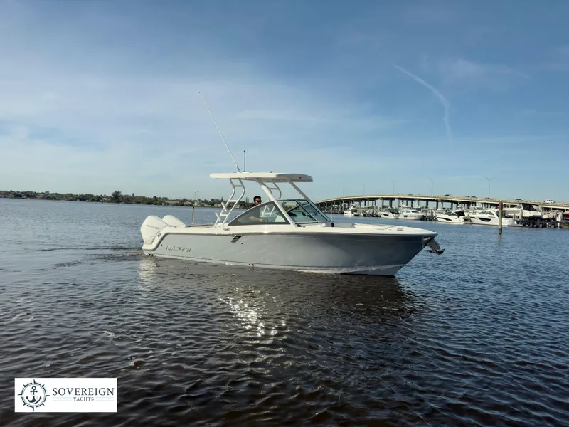 Slide: The Image of 2024 Blackfin 252 DC boat on calm water near a marina. - 9