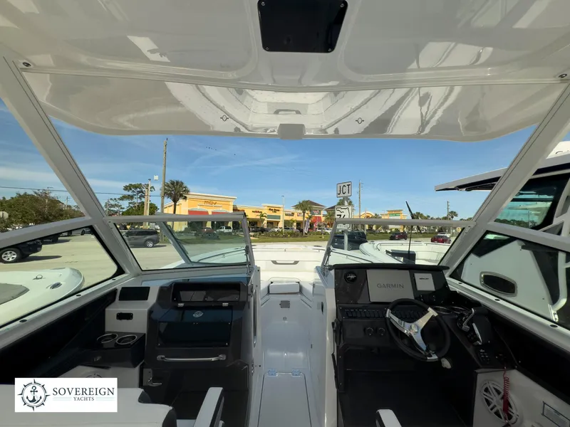 Slide: The Image of 2024 Blackfin 272 DC boat interior with modern dashboard and open cockpit. - 14