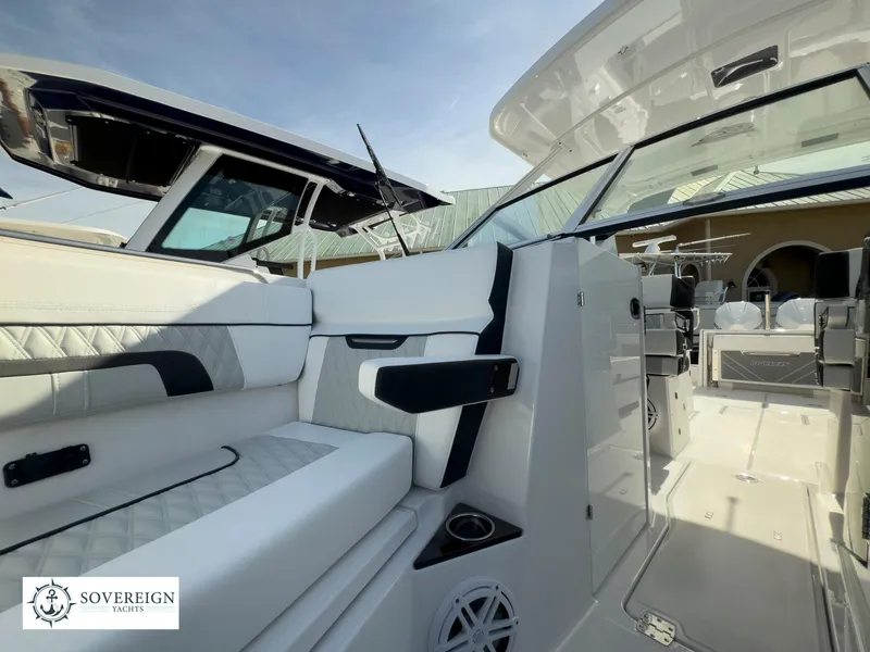 Slide: The Image of 2024 Blackfin 272 DC boat interior with white seating and modern design. - 20