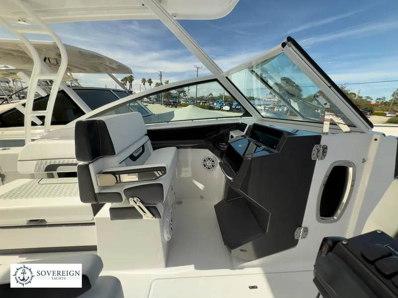 Slide: The Image of 2024 Blackfin 272 DC boat interior with helm station and seating. - 22