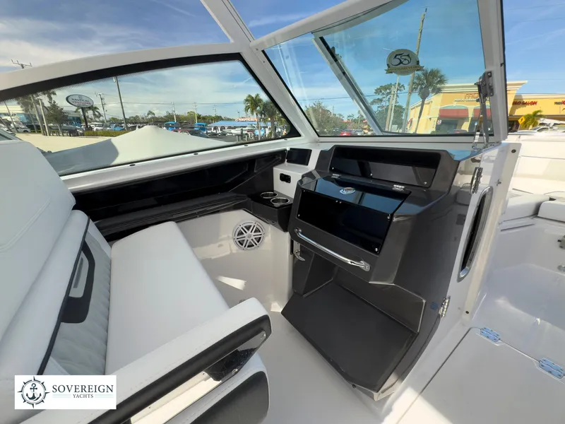 Slide: The Image of 2024 Blackfin 272 DC boat interior with modern helm and seating. - 23