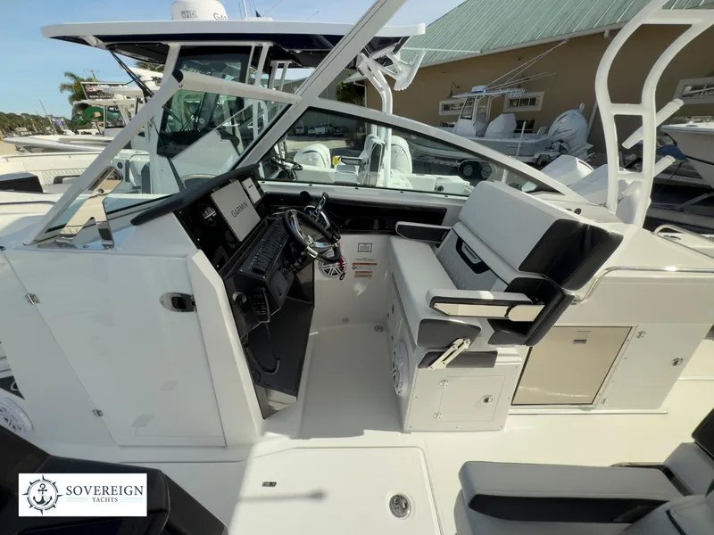 Slide: The Image of 2024 Blackfin 272 DC boat cockpit with helm and seating area. - 26