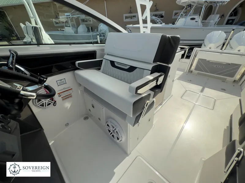 Slide: The Image of 2024 Blackfin 272 DC boat interior with helm seat and dashboard. - 27