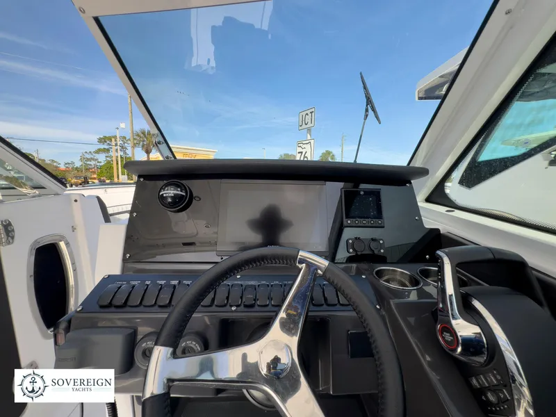 Slide: The Image of 2024 Blackfin 272 DC helm with modern controls and navigation display. - 29